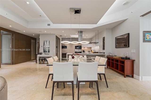 dining room featuring a tray ceiling and wine cooler