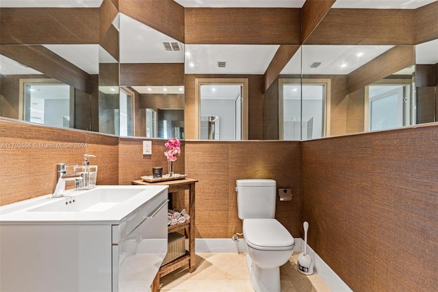 bathroom with tile patterned flooring, vanity, and toilet