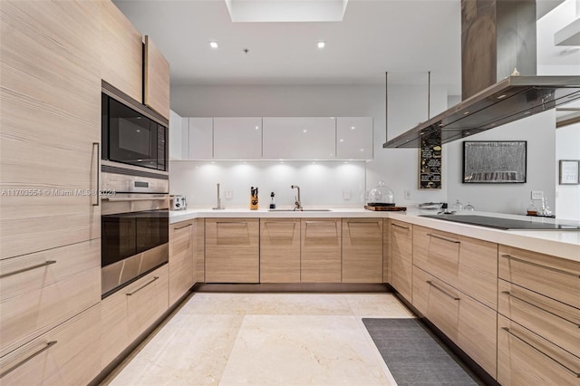 kitchen featuring white cabinets, sink, light brown cabinetry, appliances with stainless steel finishes, and island range hood