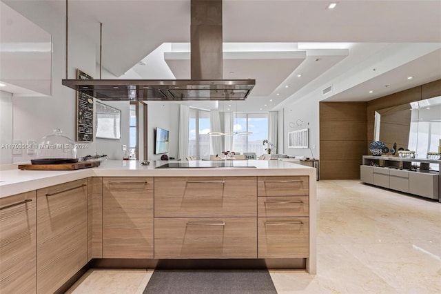 kitchen featuring black electric cooktop, island range hood, and light brown cabinetry