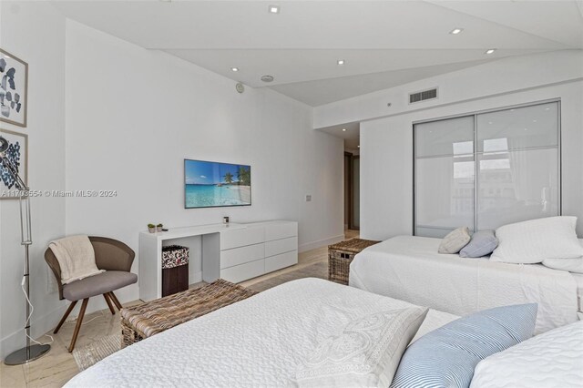 bedroom featuring light hardwood / wood-style floors and vaulted ceiling