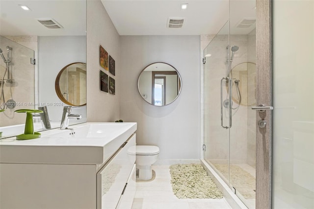 bathroom featuring vanity, toilet, and a shower with shower door