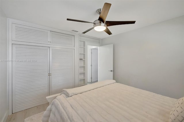 bedroom with ceiling fan, a closet, and light wood-type flooring