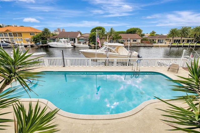 view of swimming pool featuring a water view