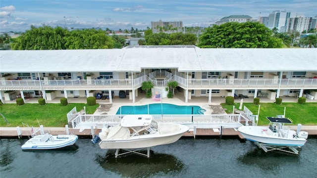 exterior space featuring a patio area, a yard, and a water view