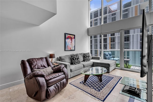 living room featuring a towering ceiling