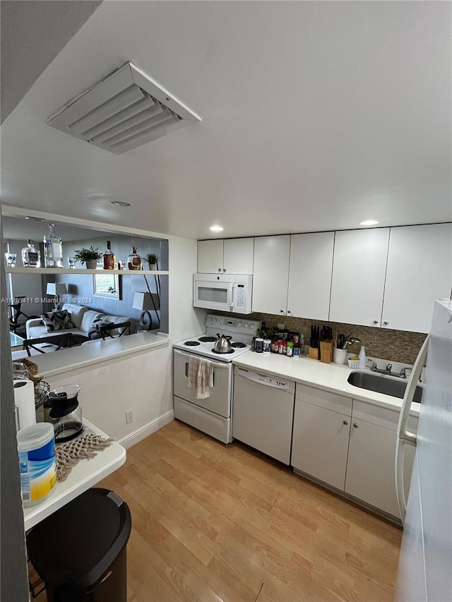 13499 Biscayne Blvd Unit 1601, North Miami, FL 33181 - kitchen featuring white appliances, white cabinets, tasteful backsplash, light wood finished floors, and recessed lighting
