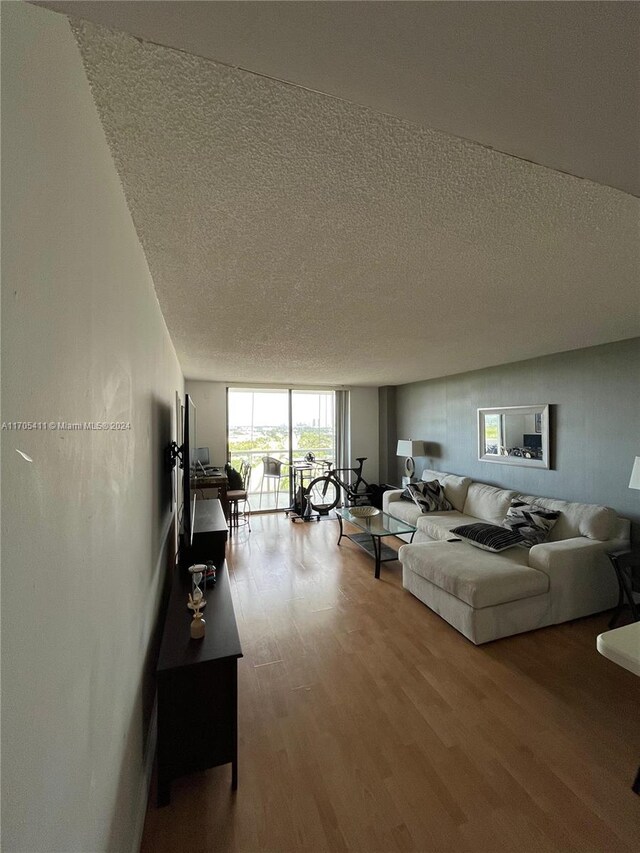 13499 Biscayne Blvd Unit 1601, North Miami, FL 33181 - living area with a textured ceiling, wood finished floors, and a wall of windows