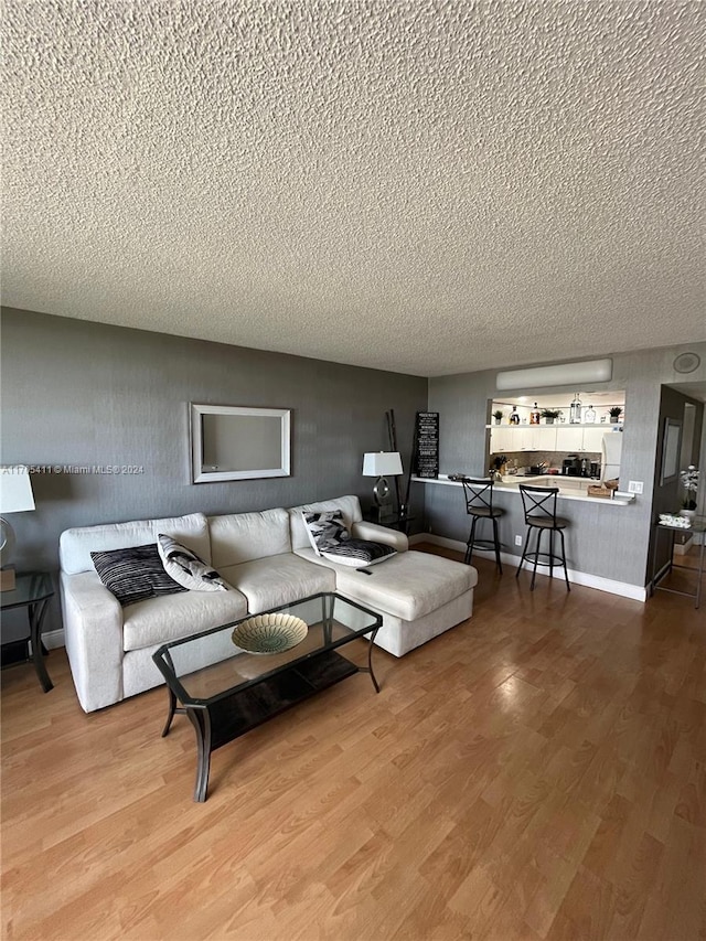 living room with hardwood / wood-style floors and a textured ceiling