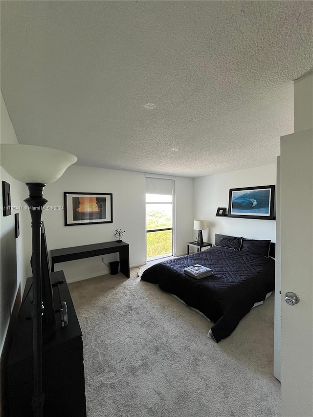 carpeted bedroom featuring a textured ceiling