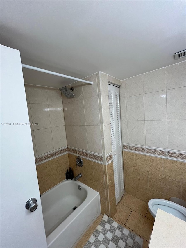 13499 Biscayne Blvd Unit 1601, North Miami, FL 33181 - bathroom with tile walls, shower / bathtub combination, tile patterned flooring, and vanity