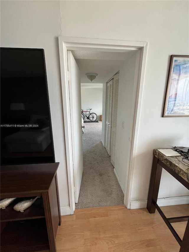 hallway with light hardwood / wood-style flooring