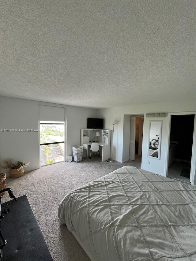 bedroom featuring carpet flooring and a textured ceiling