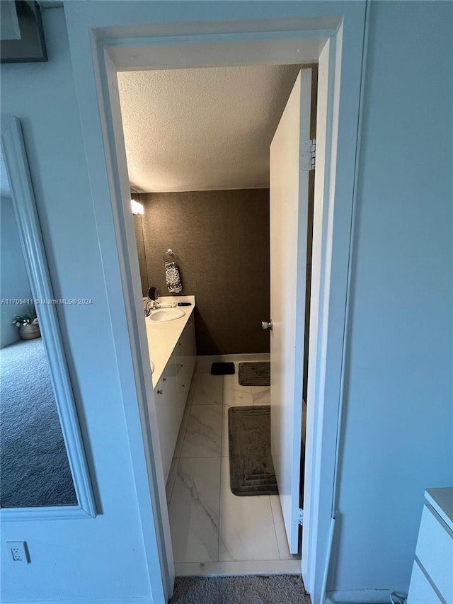 bathroom with a textured ceiling and vanity