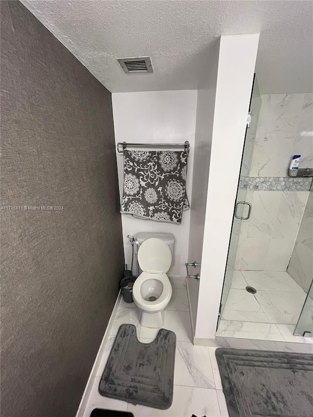 13499 Biscayne Blvd Unit 1601, North Miami, FL 33181 - bathroom with a marble finish shower, marble finish floors, and a textured ceiling