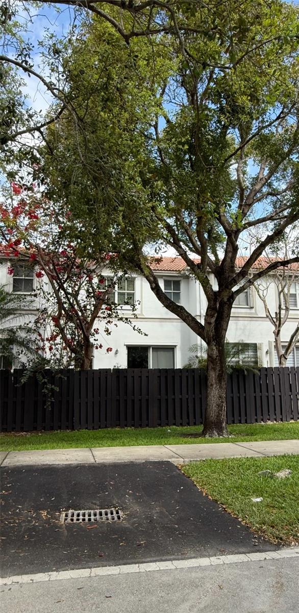 view of front of house featuring fence and stucco siding