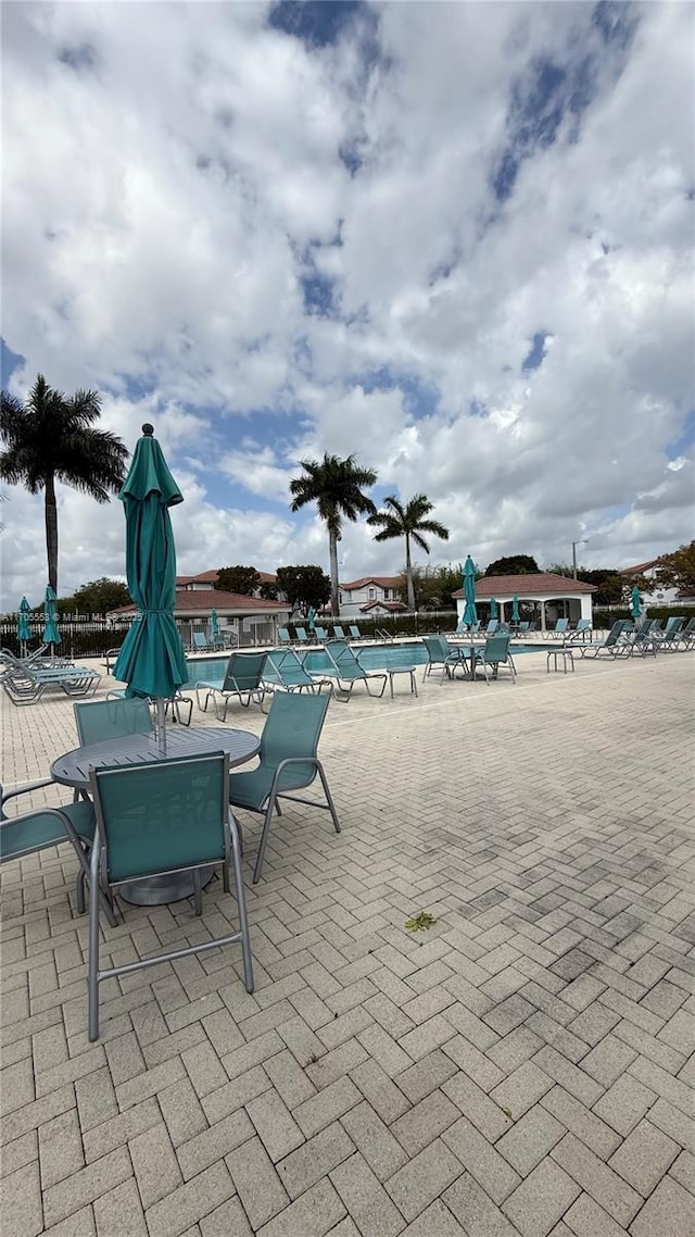 pool featuring a patio area and fence