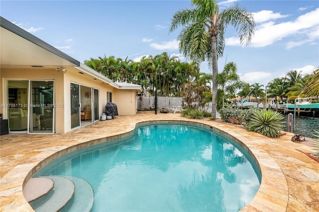 view of swimming pool with a fenced in pool, fence, a grill, and a patio area