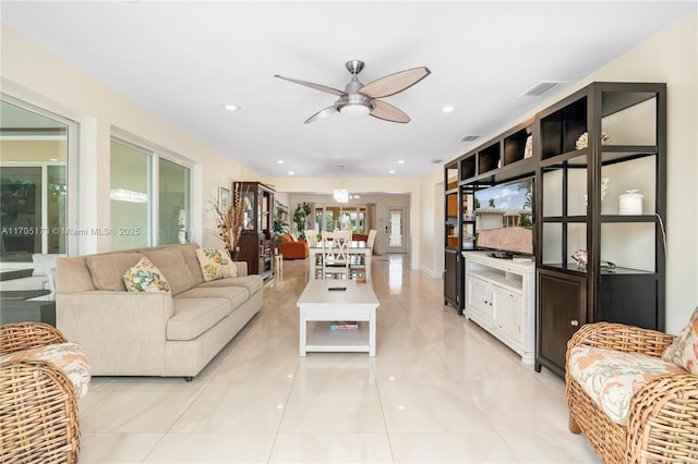 living room with ceiling fan and light tile patterned floors