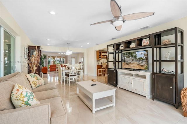 living room with ceiling fan and light tile patterned flooring