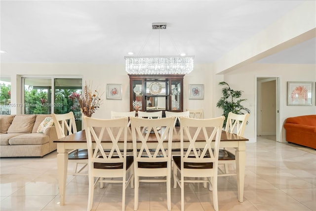 tiled dining area featuring a chandelier