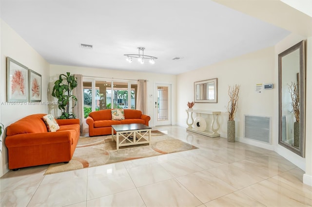 living room with baseboards and visible vents