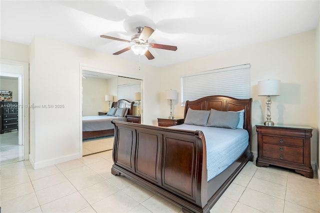 tiled bedroom with ceiling fan and a closet