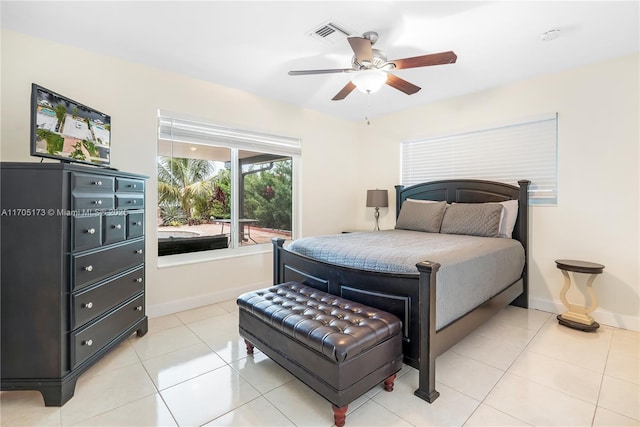 bedroom with light tile patterned flooring, visible vents, ceiling fan, and baseboards