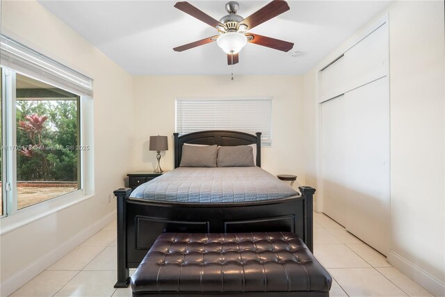 tiled bedroom featuring ceiling fan