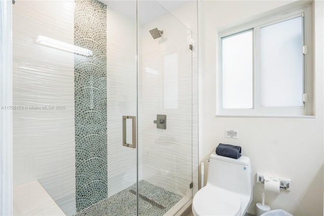 full bath with a wealth of natural light, toilet, and a shower stall