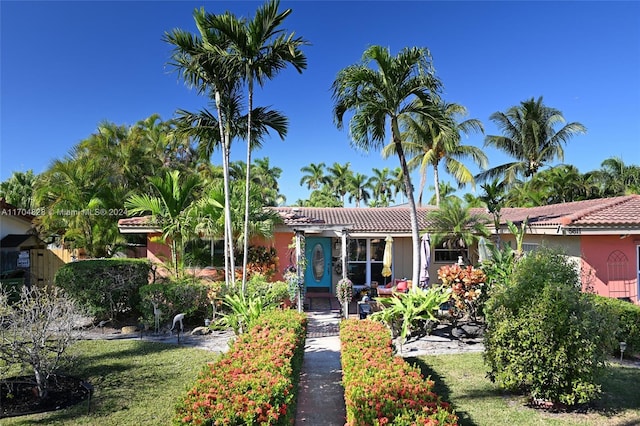 mediterranean / spanish home with a front lawn