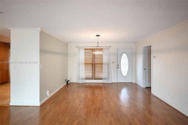 interior space with crown molding, wood-type flooring, and a textured ceiling