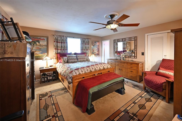 tiled bedroom featuring ceiling fan