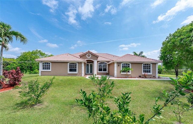 mediterranean / spanish-style house featuring a front lawn