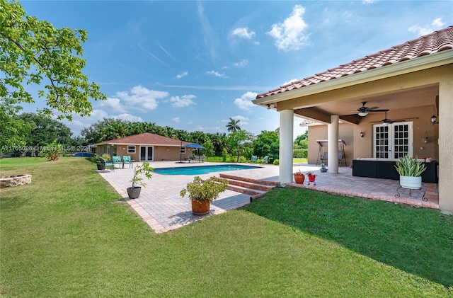 view of pool featuring ceiling fan, a patio area, french doors, and an outdoor structure