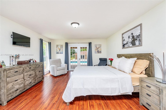 bedroom with access to exterior, dark hardwood / wood-style floors, and french doors