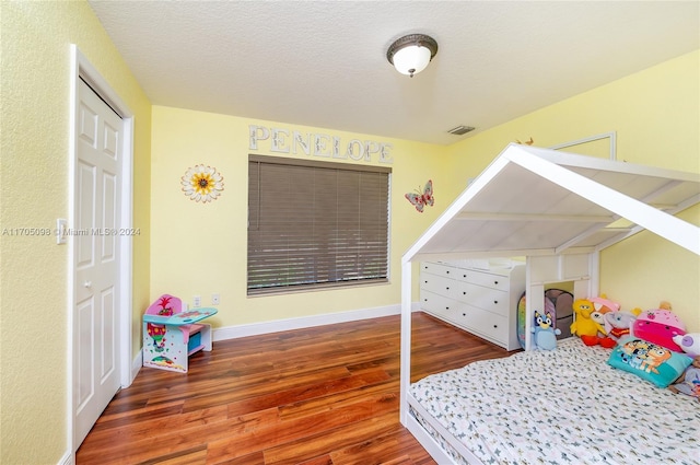 bedroom with dark hardwood / wood-style flooring