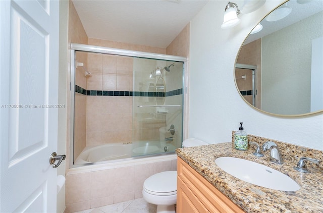 full bathroom featuring tile patterned floors, toilet, vanity, and shower / bath combination with glass door