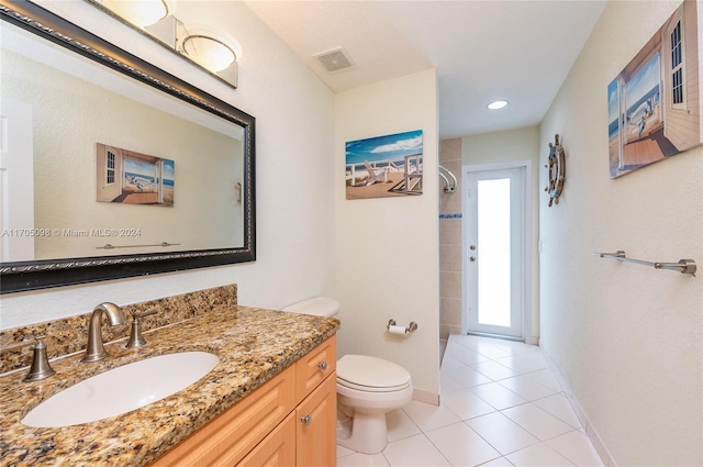 bathroom with a shower, tile patterned floors, toilet, and vanity