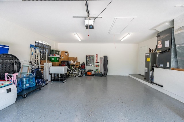 garage featuring a garage door opener, heating unit, and electric water heater