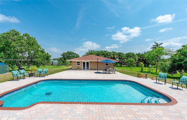 view of pool with a patio area and an outdoor structure