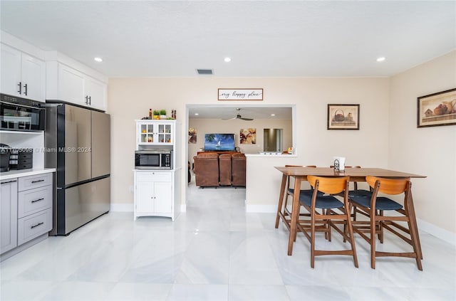 dining area with light tile patterned floors and a textured ceiling