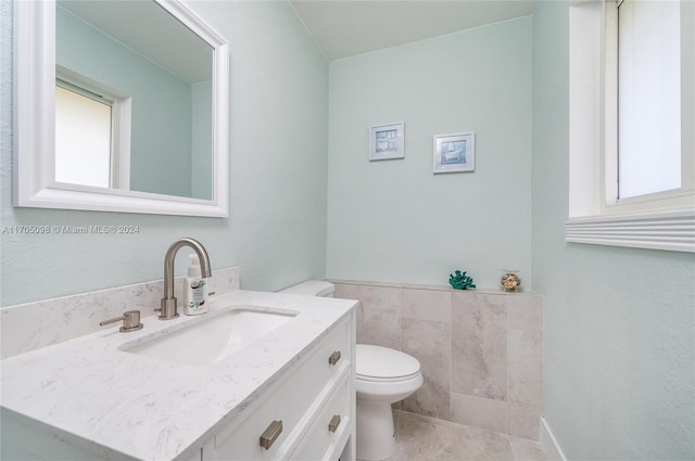 bathroom featuring toilet, tile patterned floors, and vanity