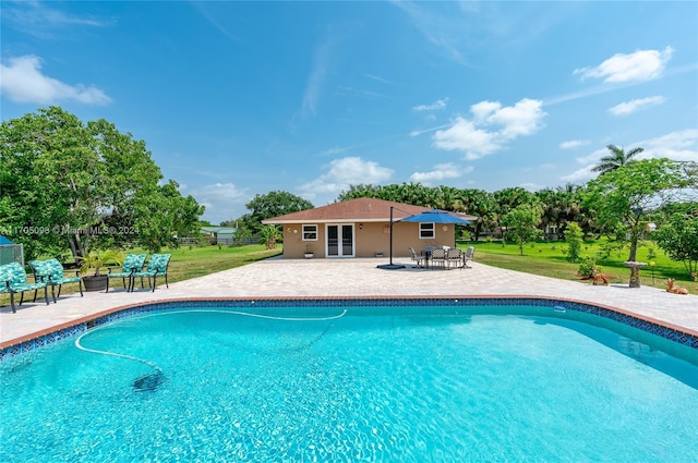 view of swimming pool featuring a patio area and a lawn