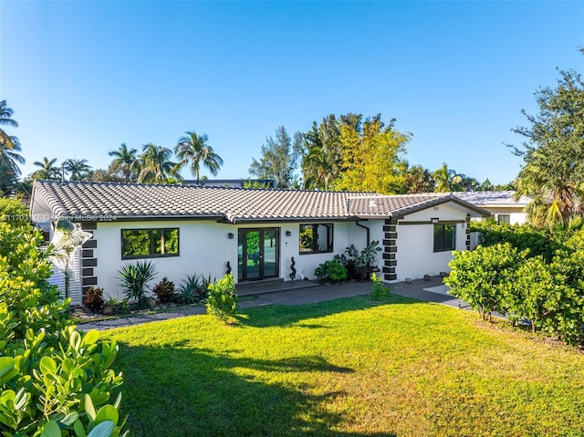 rear view of property featuring a yard