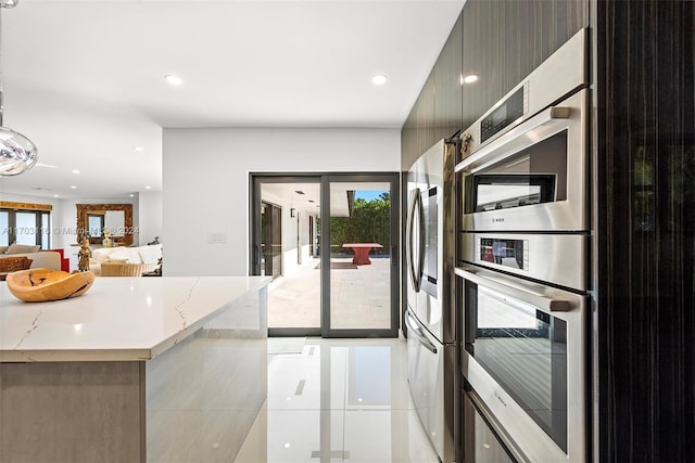 kitchen with stainless steel fridge and light stone counters