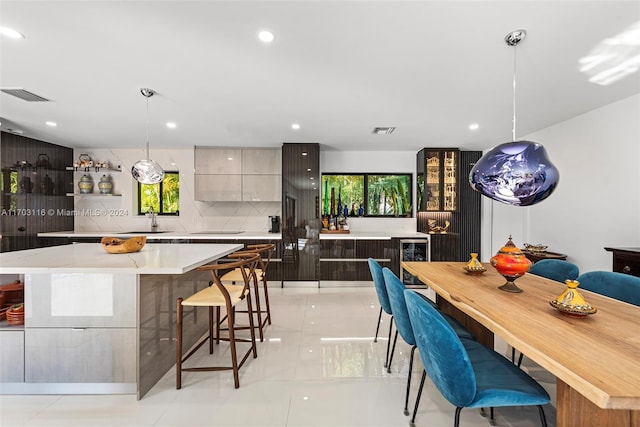 dining space featuring light tile patterned floors, sink, and wine cooler