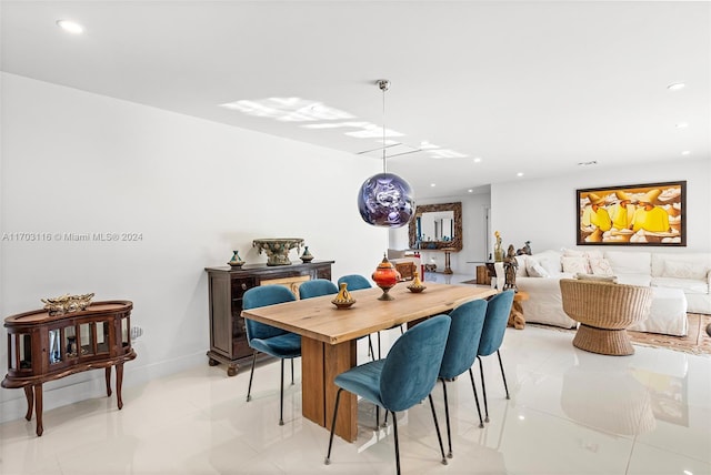 dining area featuring light tile patterned flooring