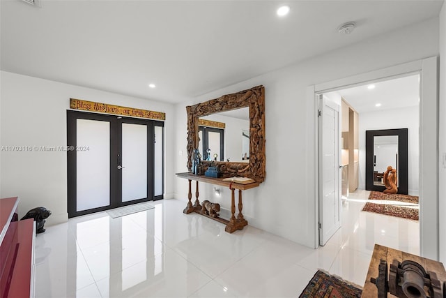 corridor featuring french doors and light tile patterned flooring