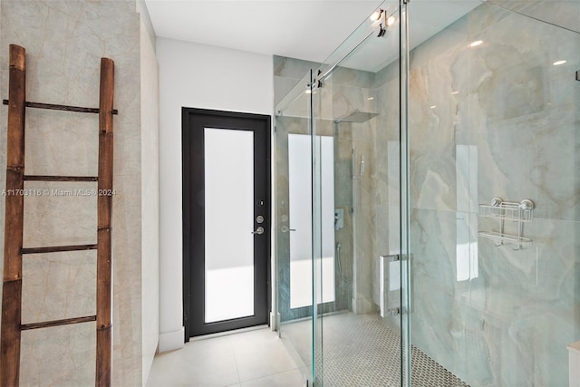 bathroom featuring tile patterned floors and a shower with shower door